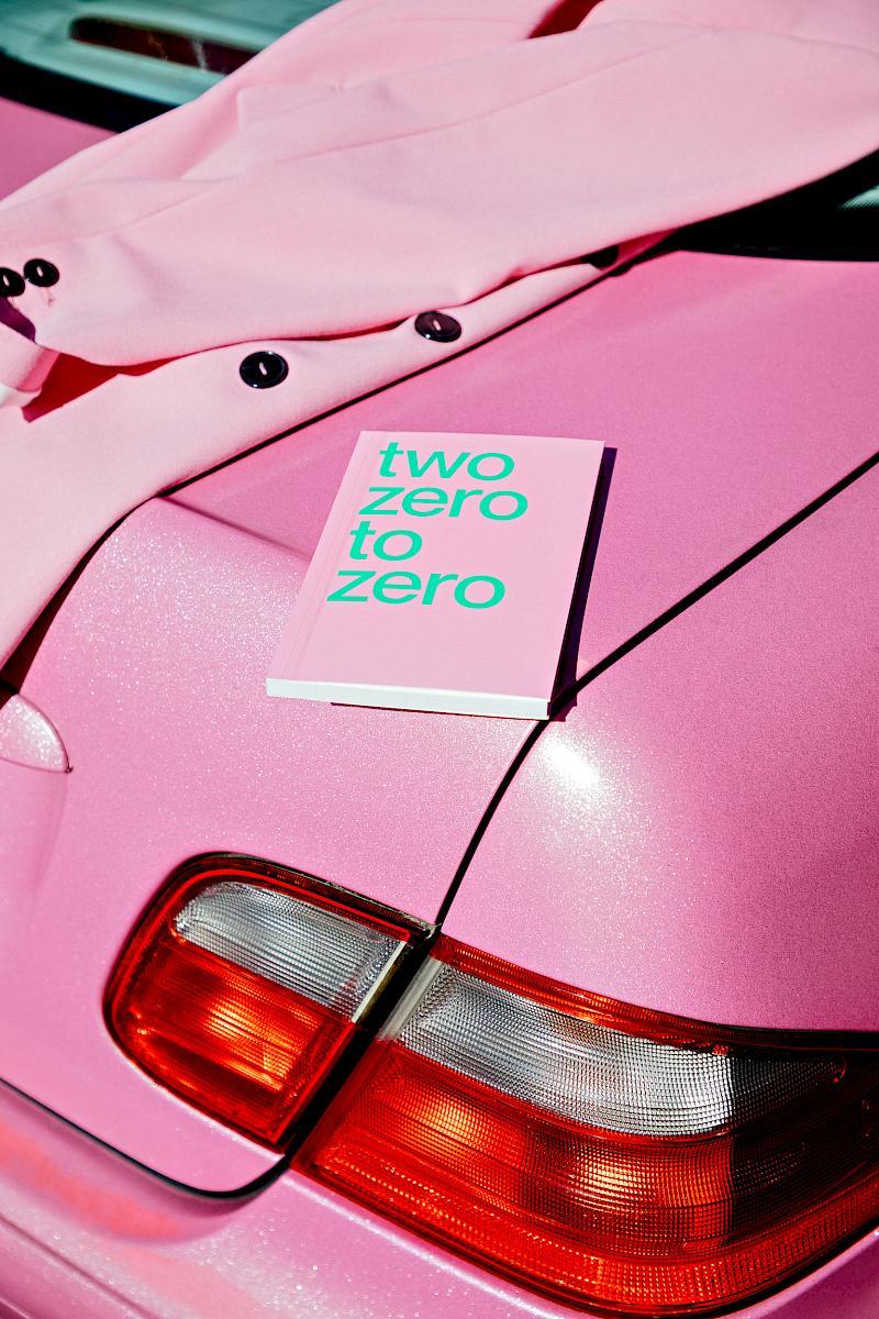 A pink planner and a pink blazer on a pink Mercedes Benz car