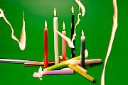 Colourful candles on a green background with light drawing