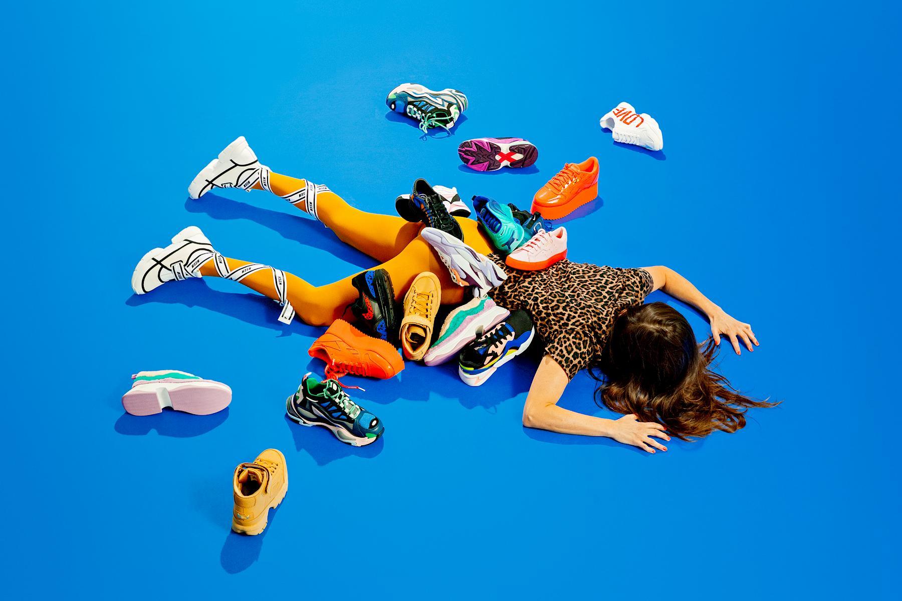 Shopping addict buried in sneakers. Still life for Friday Magazin