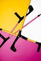 Bright yellow and pink crutches on a yellow and pink background