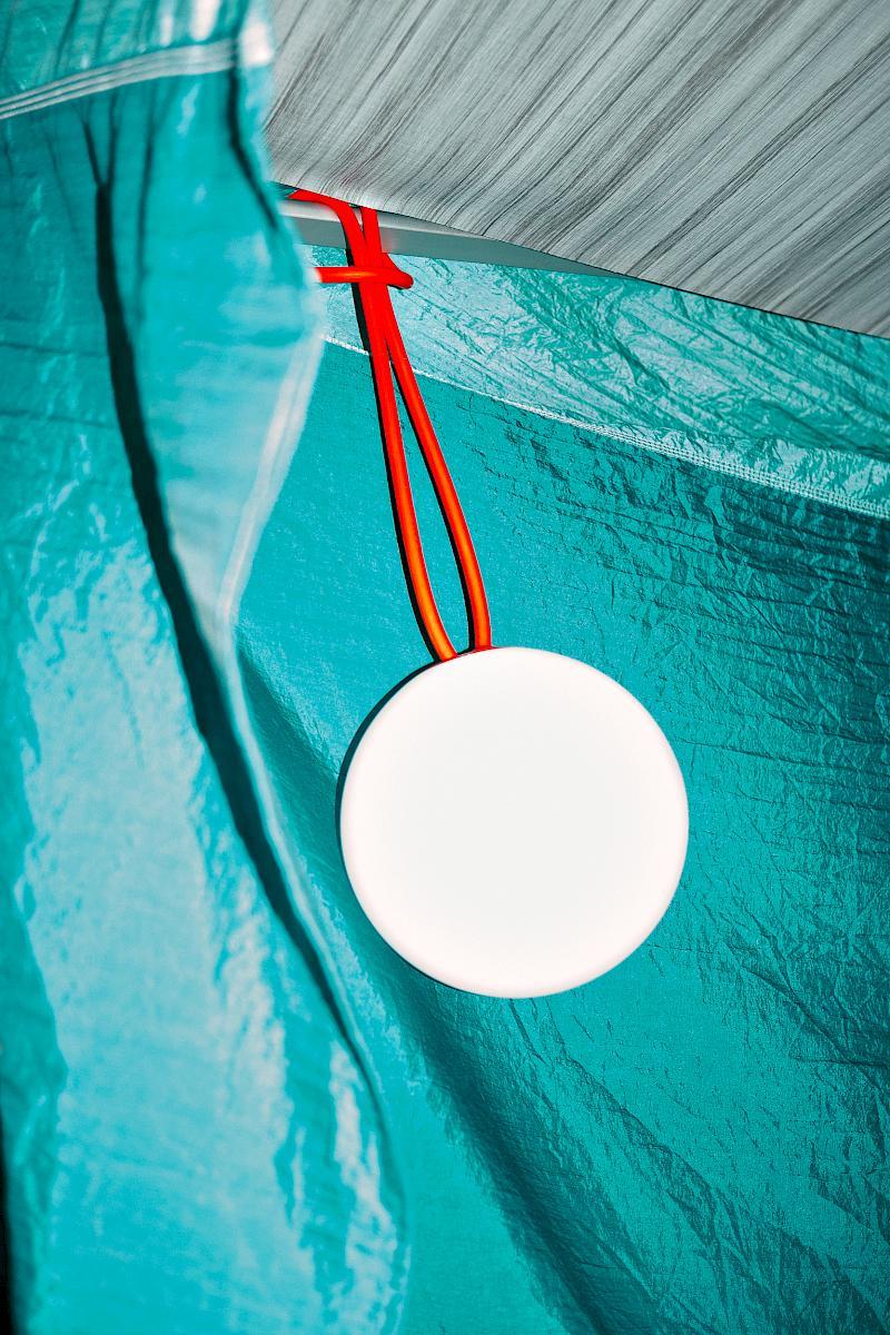 Fatboy Bolleke portable LED light by Alex Bergman in front of a Ticket to the Moon beach blanket