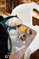 Miu Miu women's crystal cat eye sunglasses on a table with an Italian croissant and a glass of water