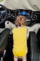 Toddler in a yellow bodysuit playing with the Mercedes Marco Polo centre console