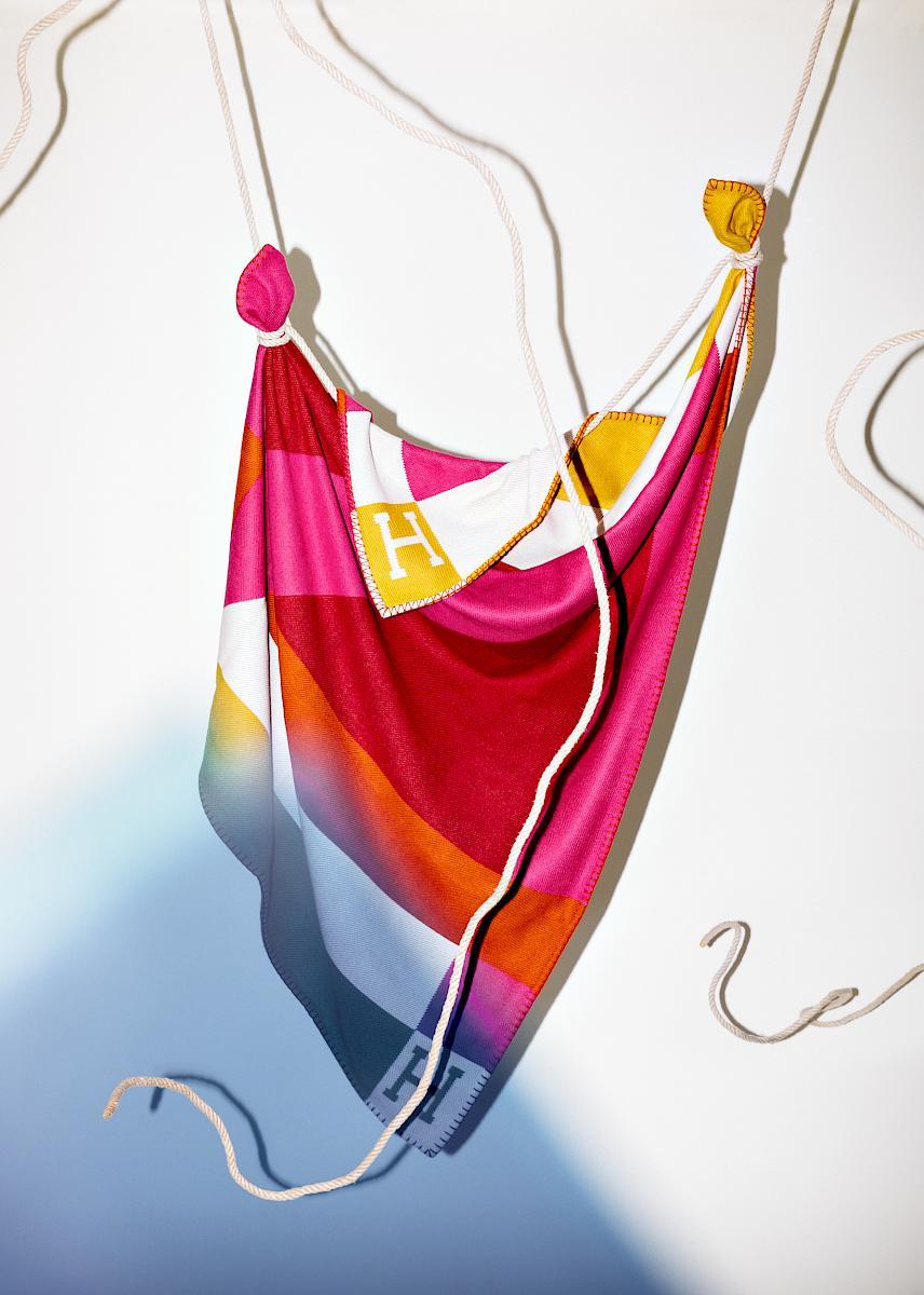 A Plaid from Hermès Hanging with Rope in Front of a White Wall