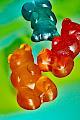 Blue, Red, and Yellow Mega Gummy Bears on a Blue-Green Background