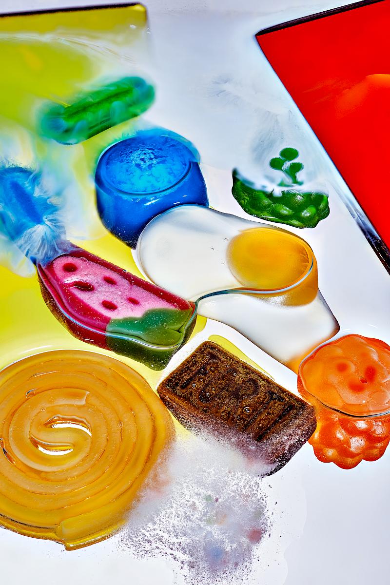 A Selection of Fruit Jelly, Bonbons, and Licorice Dissolving in Water