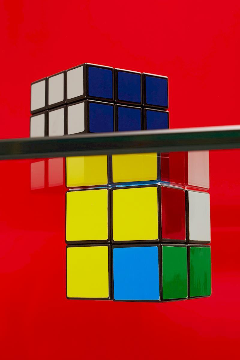 Two Rubik's Cube on a Red Background