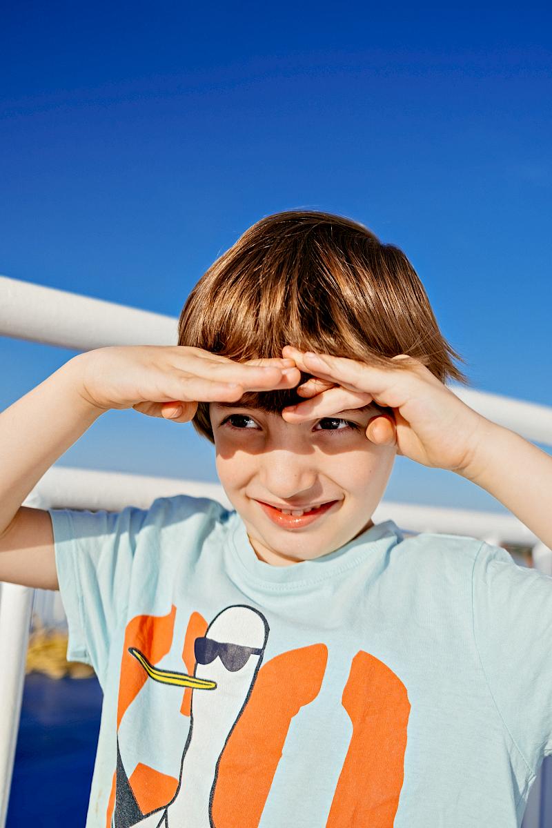 Child shielding their eyes in bright sunlight